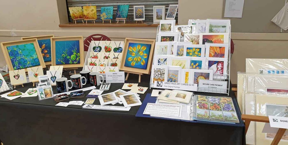 My table laid out with art cards and paintings at nelson craft market
